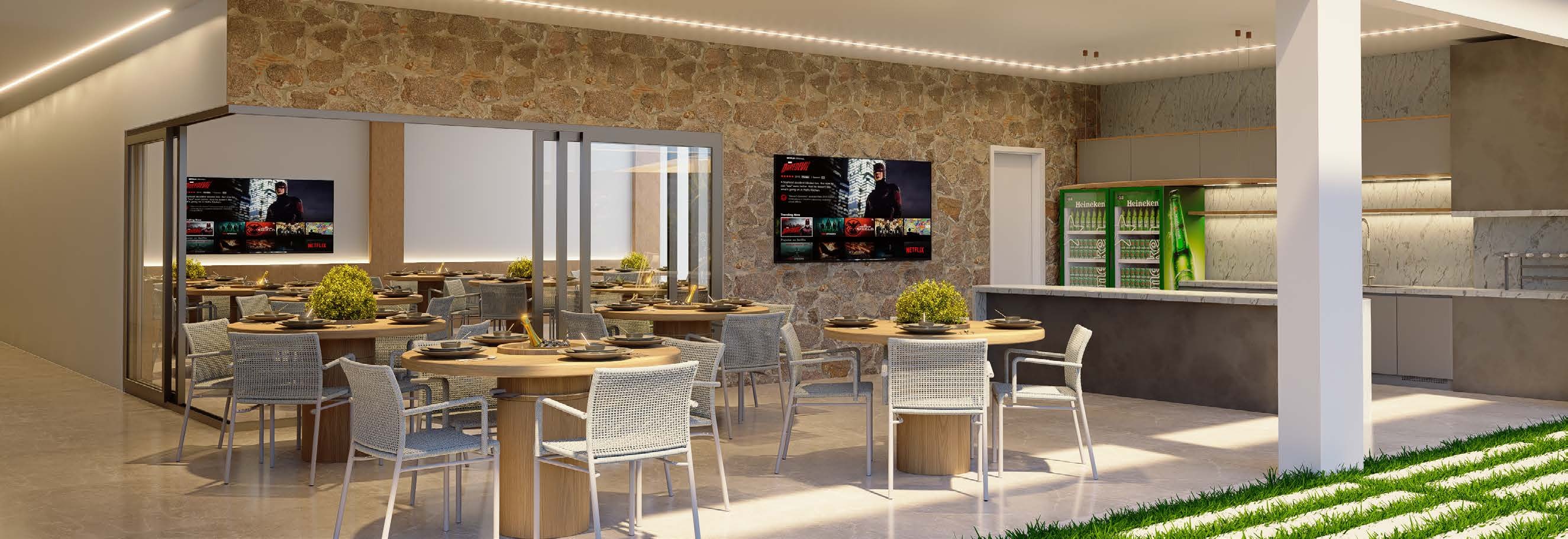 Espaço gourmet com churrasqueira, bar e mesas